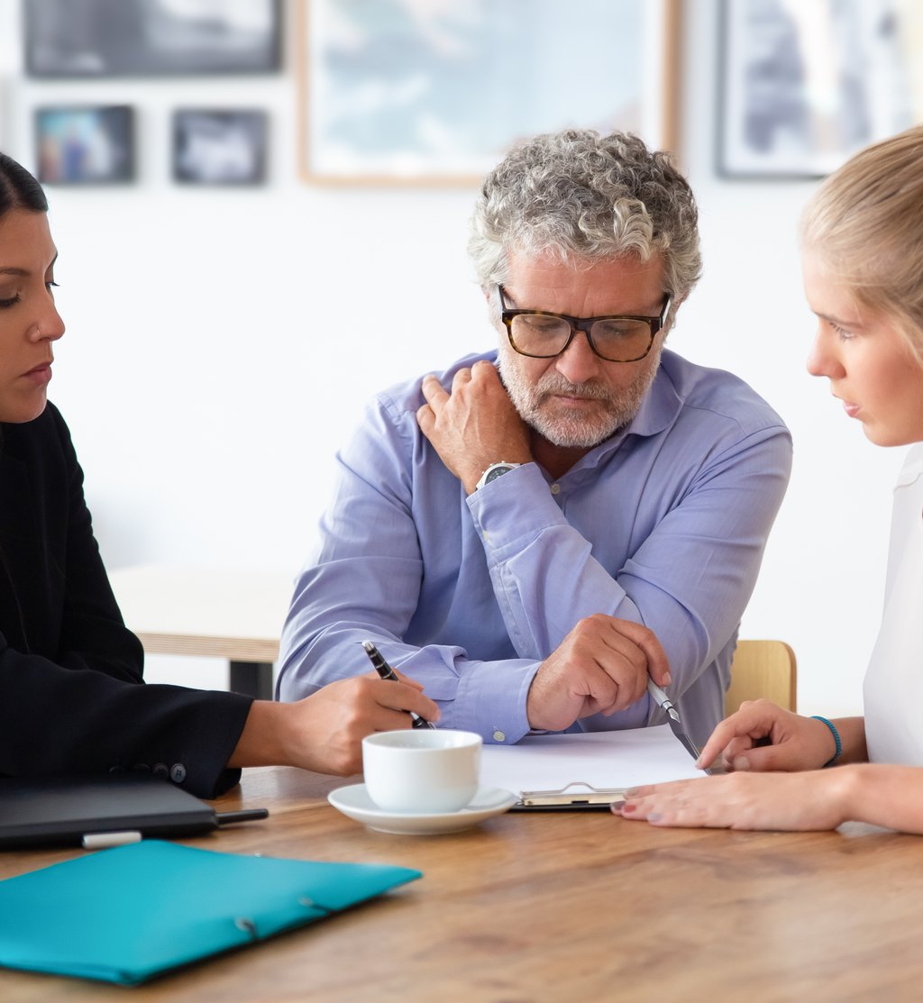 A Fisher Stone attorney going through documents with clients