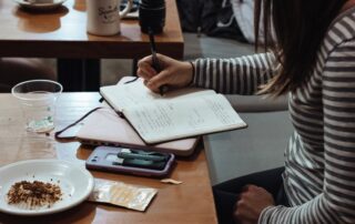 Woman at a desk writing on her LLC documents