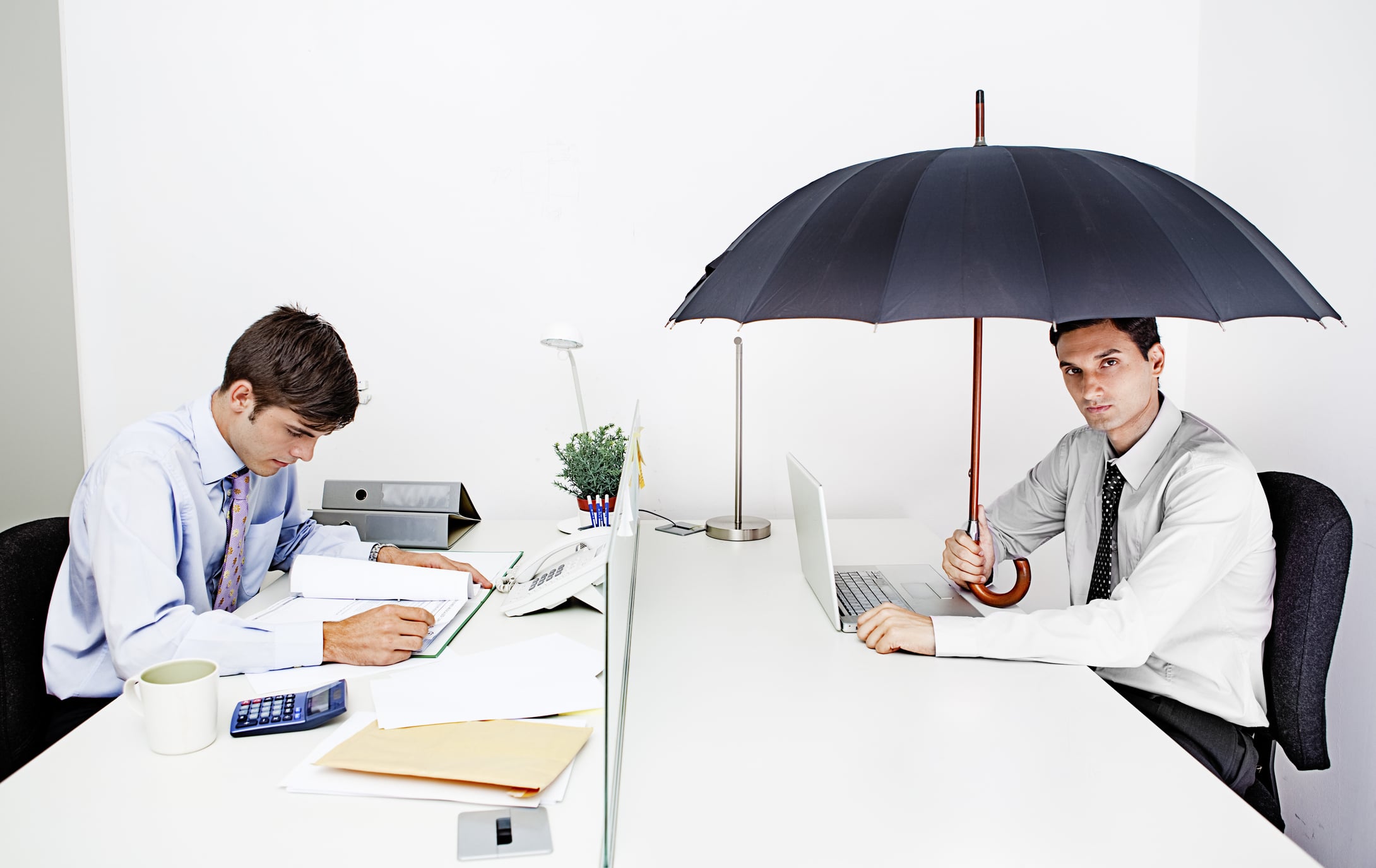 Man with umbrella at office